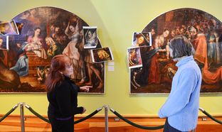 At the San Angelo Museum of Fine Arts, Mary Fredrickson, left, an art conservator, discusses restoration work she's doing with Laura Huckaby, the museum's collections manager.