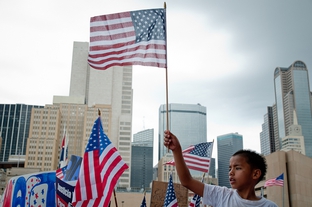 A boy waves an American flag at an immigration rally held in Dallas on May Day.