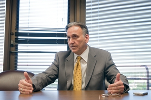 Texas Workers' Compensation Commissioner Rod Bordelon speaks to Texas Tribune reporter Elise Hu in 2010.