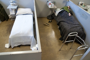 An inmate sleeps in his cubicle in the geriatric unit of the Estelle Prison in Huntsville.