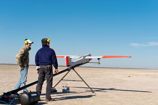 Texas A&M University-Corpus Christi engineering student Adam Ersepke and lab coordinator Jack Edward Esparza prepare for the take off of the University’s RS-16 unmanned aerial vehicle, otherwise known as a drone, for a test flight over the Kennedy Ranch near Sarita, Texas on January 18, 2013.