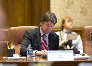 Dallas businessman Wallace Hall, Jr. takes notes at the University of Texas Board of Regents meeting on Feb. 14, 2013 in Austin.