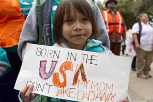 Six year old girl, holds up sign during immigration reform rally at the Texas Capitol on February 22nd, 2013