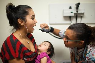 Medical assistant Alesia Bolden checks Nereyda Penaloza's vital signs during a visit to Women's Health at CommUnityCare, a federally qualified health center, in Austin, Texas.