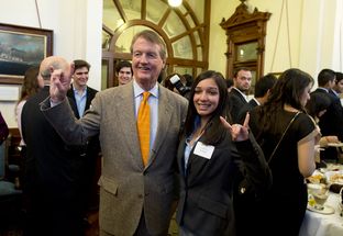 UT President Bill Powers does the "Hook-em 'Horns" with student Lariza Uribe at the Texas Capitol on Mar. 5, 2013.