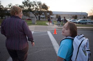 Stacy Ford taking her daughter, Aurora, who is 11 years old and has Down Syndrome, to school on Tuesday, March 19, 2013.