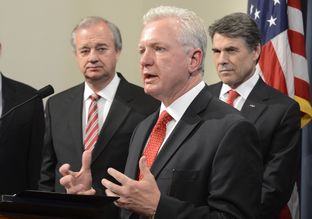 Flanked by A&M Chancellor John Sharp, l, and Gov. Rick Perry, Dr. Brett Giroir, M.D. of the Texas A&M System at the vaccine research lab announcement on March 26, 2013.