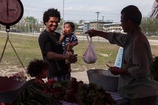 Tiger Whitehead and his children Logic and Domnick, who used SNAP and the the Sustainable Food Center Farmer's Market double dollars coupons, shopping at the Farmer's Market at 2835 East MLK Blvd. in Austin on March 19, 2013.