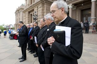 Texas Catholic bishops along with Cardinal Daniel DiNardo of Houston, l, pray on the South Steps of the Capitol on April 9, 2013.
