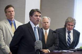 Gov. Rick Perry announces a 5 percent cut in the Texas franchise tax for small business on April 15, 2013. In the background are Rep. Harvey Hildebran, R-Kerrville, Gary Farmer of the Austin Chamber and MIke Morrissey of the governor's staff.