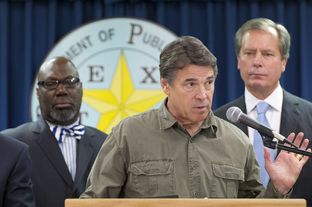 Flanked by Education Commissioner Michael Williams, l, and Lt. Gov. David Dewhurst, Gov. Rick Perry makes a statement on the West, TX disaster on April 18, 2013.
