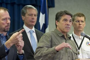 Gov. Rick Perry, r, answers a question on the West, TX disaster at DPS headquarters on April 18, 2013.