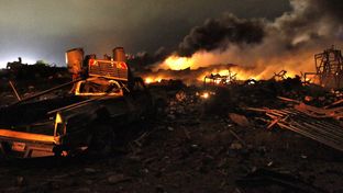 A vehicle near the remains of a fertilizer plant burning after an explosion in West, Texas, near Waco.