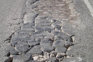 A road in the Eagle Ford Shale area in South Texas. The natural gas drilling boom is straining the region's rural roads. More than 1,000 loaded trucks are needed to bring a single well into production.