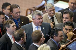 State Rep. Allen Fletcher, R-Cypress, stands among House members during the consideration of a point of order on a campus carry bill on May 4, 2013.