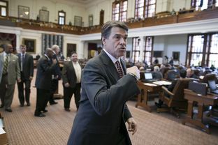 Gov. Rick Perry leaves the House chamber after speaking and visiting with members on May 13, 2013.