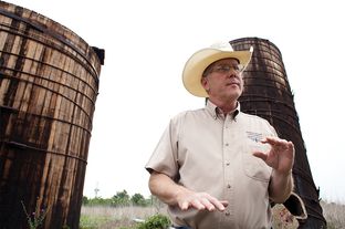 Landowner Stuart Carter, in Central Texas near the town of Luling, has years of abandoned oil equipment on his property. Here, two oil wooden oil tanks that he says date to the 1920s.