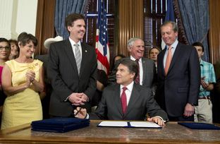 Gov. Rick Perry after signing House Bill 5, an education reform bill, before a crowd in the Governor's Reception Room on June 10, 2013.