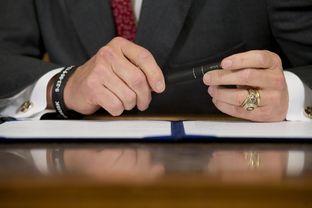 Gov. Rick Perry prepares to sign a series of education reform bills in the Governor's Reception Room on June 10, 2013.