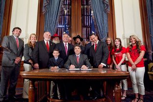 Gov. Rick Perry signs House Bill 308 which allows public school students and staff to use traditional holiday greetings and display religious symbols on school property. He was joined by bill author Rep. Dwayne Bohac R-Houston, Bahac's son Reagan, Sen. Robert Nichols as well as several Santa's, Rabbi Zev Johnson and cheerleaders from Kountze High School - June 13, 2013.