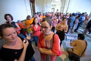 Activists gathered near the Senate chamber as SB5, a bill regulating Texas abortions, comes up for a vote on the last day of a special session in Austin.