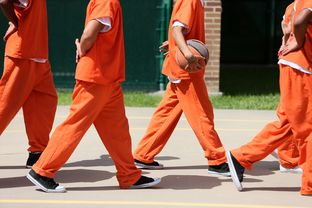 Detainees line up to leave the outdoor recreation area at theTravis County Juvenile Detention Center in Austin on June 24, 2013.