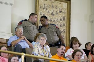DPS officers confer in the galley at the start of the Senate second called special session on July 1, 2013.