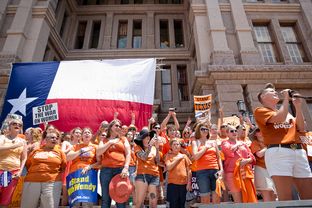 Natalie Maines sings the National Anthem at the Texas Women Rally at the Capitol.