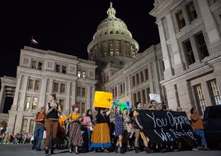 Abortion rights protesters march out of a House State Affairs Committee hearing on July 3, 2013.