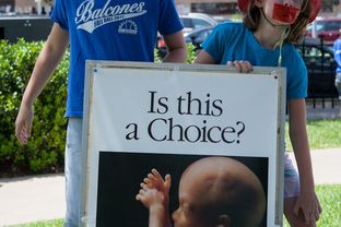 Young attendees, wearing the blue of anti-abortion protesters, attend demonstrations at the Texas State Capitol on the first day of the second legislative session, July 1, 2013.