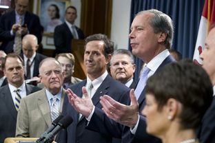 Lt. Gov. David Dewhurst, r, speaks to the Capitol press on pending Senate votes on the abortion bill as Rick Santorum and other House members listen on July 11, 2013.