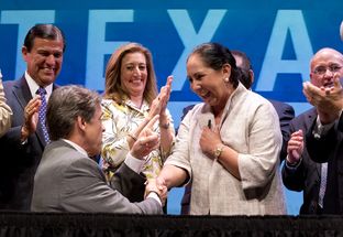 Gov. Rick Perry and Juliet García of the University of Texas at Brownsville at a signing ceremony on July 16, 2013, for the merger of UT-Brownsville and UT-Pan American.