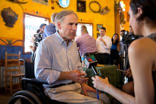 Texas Attorney General Greg Abbott speaks with a reporter for Univision on July 16, 2013, during a gubernatorial campaign event at El Pato restaurant in McAllen.