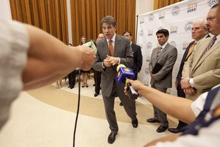 Gov. Rick Perry answers a question on the south Texas university merger following the ceremony at UT-Brownsville on July 16, 2013.
