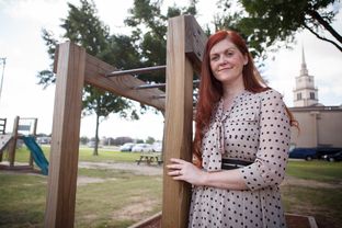 Latisha Andrews is shown on the playground of Beta Academy, which is housed at the Christian Temple Assembly of God Church in Houston on Aug. 6, 2013. She is applying to convert the private school into a charter school.