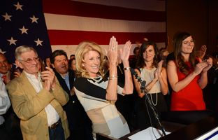 State Sen. Wendy Davis, flanked by her father, Jerry Russell, and her two daughters, delivering her victory speech at the Fort Worth Hilton on Nov. 6, 2012.