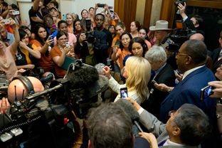 Crowds gather outside the Senate hallway to hear State Sen. Wendy Davis after the midnight drama that killed abortion legislation in the last hour of the 83rd Texas legislature's first called special session.