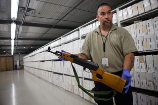 Evidence Specialist, Richard Castro, shows a firearm held as evidence by APD. The Austin Police Department’s evidence and seized property storage facility contains thousands of firearms from handguns to assault rifles dating back as far as the 1970s.