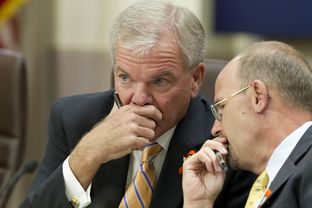 Texas Transportation Commission chair Ted Houghton, l, confers with TXDOT Executive Director Phil Wilson during the meeting on August 29, 2013 regarding budget shortfalls.