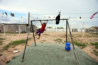A young girl plays outside her home in the Pueblo de Palmas colonia near Mission, Texas, on Aug. 29, 2013.