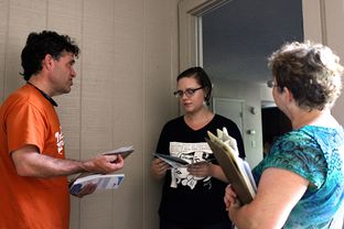 Kenneth Flippin, left, and Jane Denson, right, of Enroll America at the home of Shelby Childress.