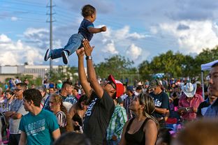 Terry Garcia plays with his son, Eli, 1, at the Festival Viva Mexico 2013 on Sunday, Sept. 8, 2013, in advance of Mexican Independence Day at a former greyhound racetrack in Corpus Christi.