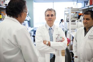 Ronald DePinho, president of the University of Texas MD Anderson Cancer Center, visiting labs on the south campus in Houston on Sept. 30, 2013.