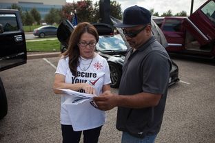 Jill Ramirez, the director of outreach for the Latino Healthcare Forum, passes out flyers and explains components of the Affordable Care Act on Oct. 5, 2013.