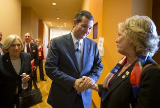 U.S. Sen. Ted Cruz greets a Texas Federation of Republican Women worker in San Antonio on October 19, 2013