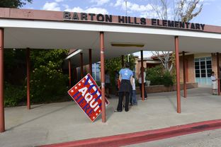 A wind-blown sign directed voters to Barton Hills Elementary, Precinct 342, Austin on Nov. 5, 2013.