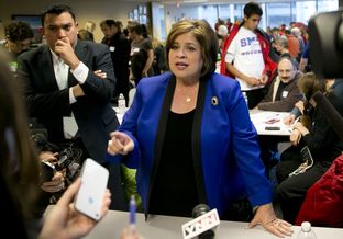State Sen. Leticia Van de Putte speaking to press during a visit to a phone bank in Austin.