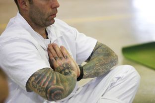An inmate practices meditation during a yoga session at the Powledge prison unit in Palestine on Tuesday, December 10, 2013.
