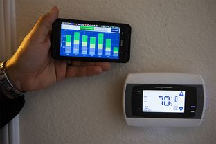 Homeowner Adam Leija demonstrating how CPS energy's "home manager program" works.