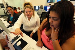 Lindsay Berlanga, center, site manager for Cognazante, helps Melissa Villareal, right, and her mother, Hortensia Villareal, rear, with registration for the Affordable Care Act during assistance hours at Bibliotech, the new digital public library in San Antonio, Friday, January 17, 2014.